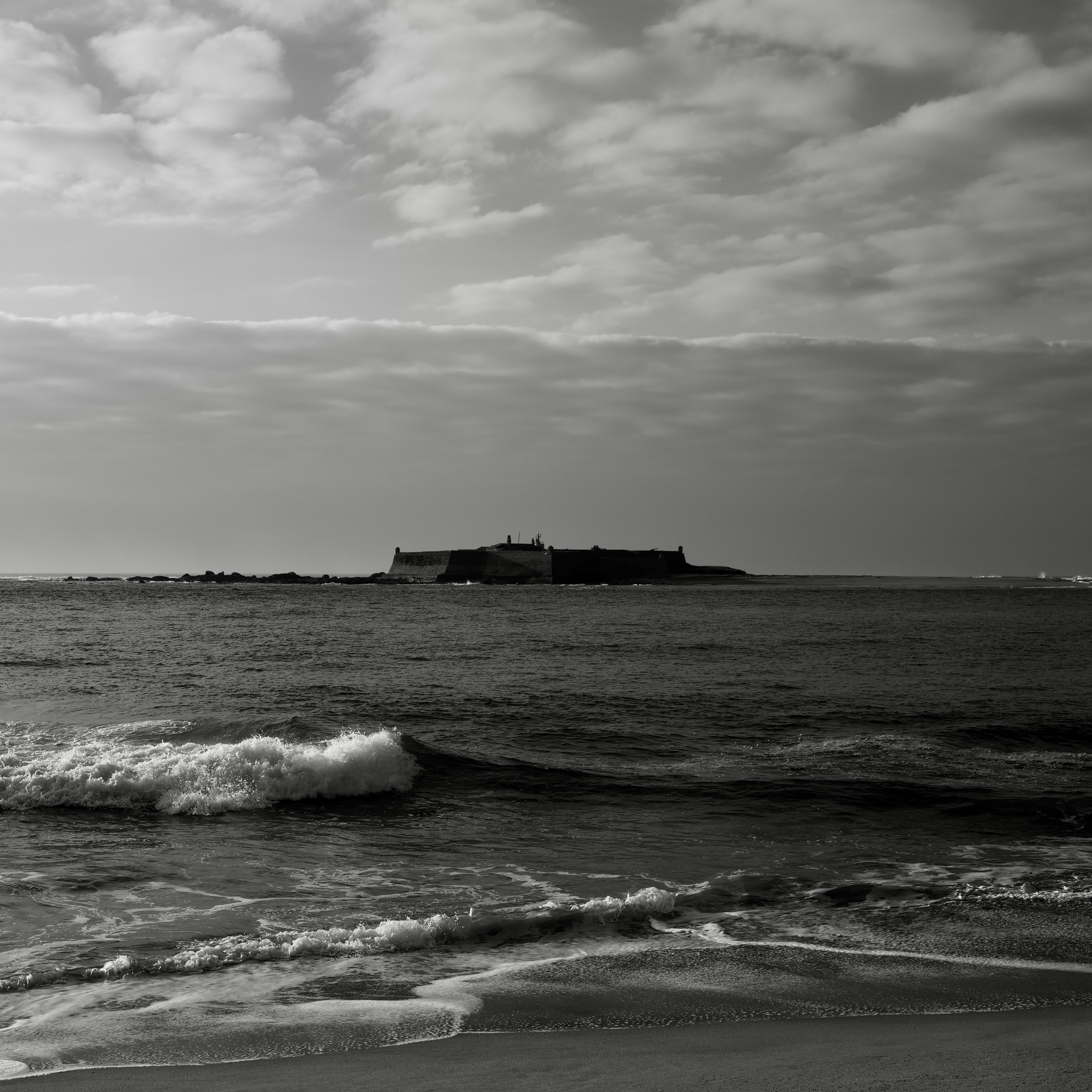 Fort in a island in the ocean seen from the shore. Caminha, Portugal - 2024